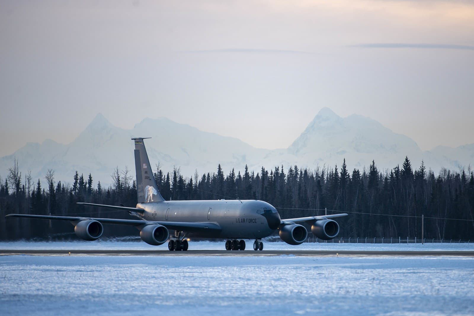An aircraft on the flightline at Eielson AFB, Alaska, with the Alaska Range behind it.