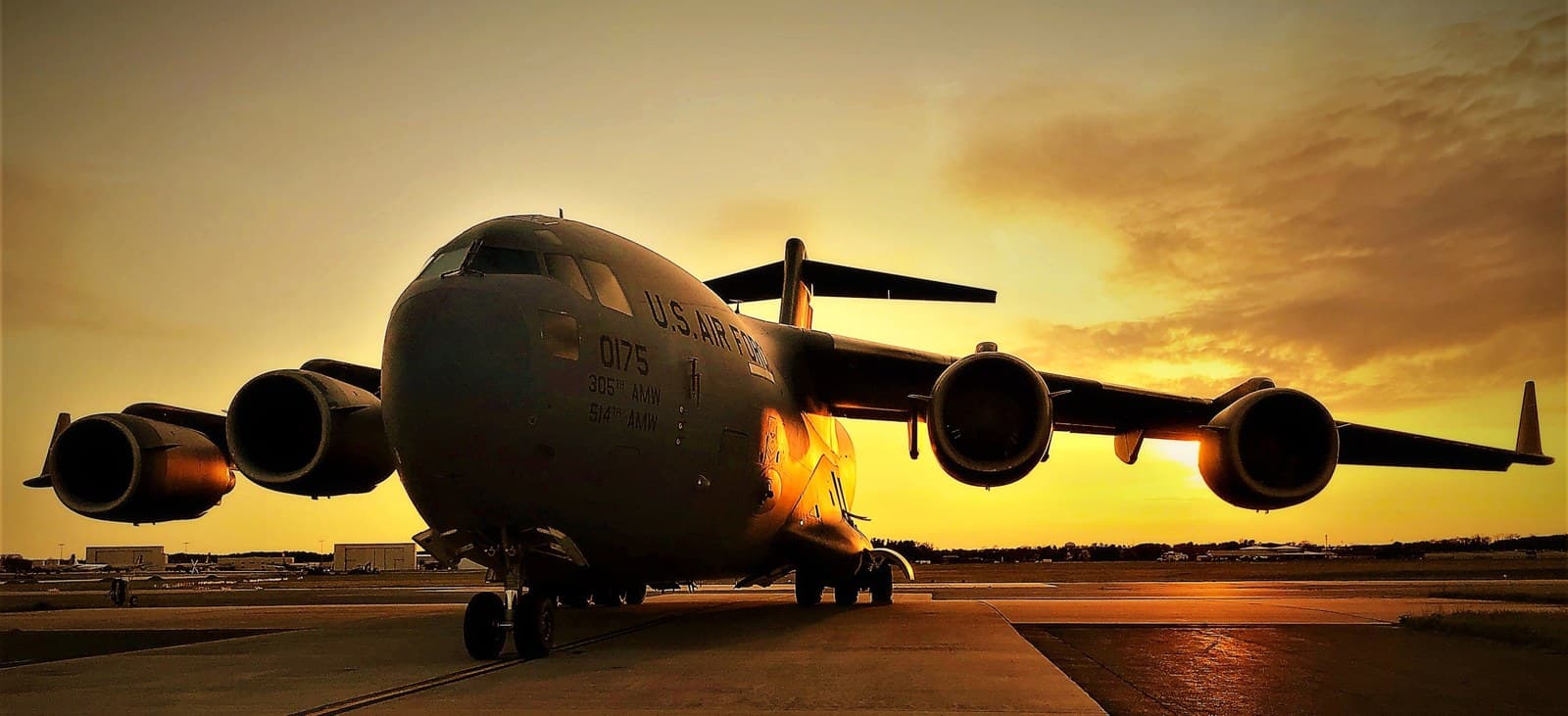 An airlift aircraft on the flightline at sunset.